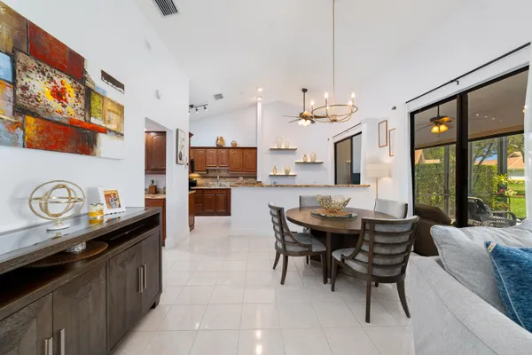 a kitchen with stainless steel appliances granite countertop a sink stove refrigerator and cabinets