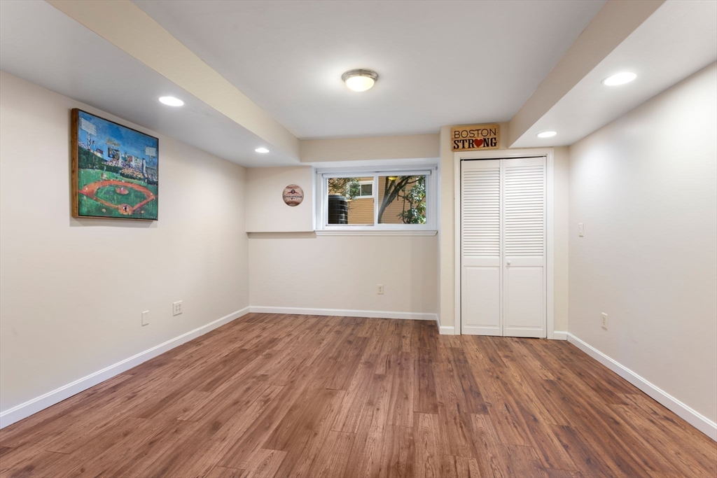 106 Captain Eames Circle, Unit 106 Ashland, MA 01721 - Photo 14 of 21 a view of empty room with wooden floor and fan