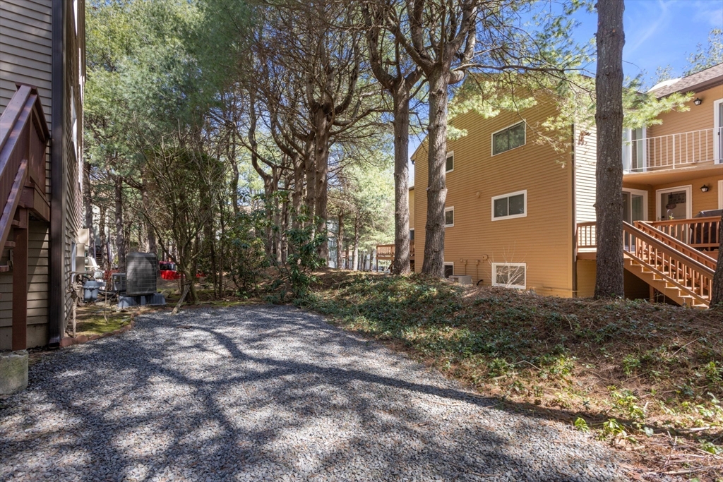106 Captain Eames Circle, Unit 106 Ashland, MA 01721 - Photo 17 of 21 a backyard of a house with lots of green space
