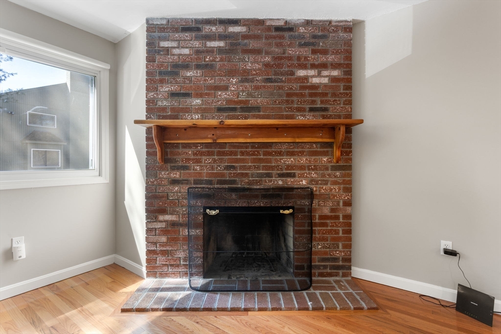 106 Captain Eames Circle, Unit 106 Ashland, MA 01721 - Photo 7 of 21 a living room with a fireplace