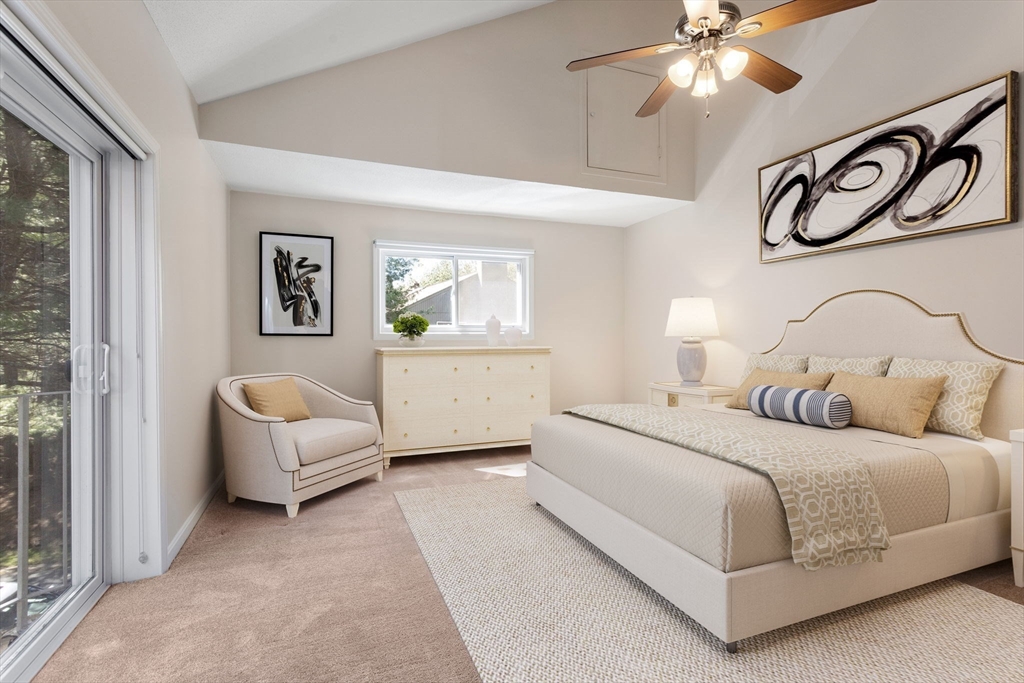 106 Captain Eames Circle, Unit 106 Ashland, MA 01721 - Photo 9 of 21 a bedroom with a bed and a chandelier