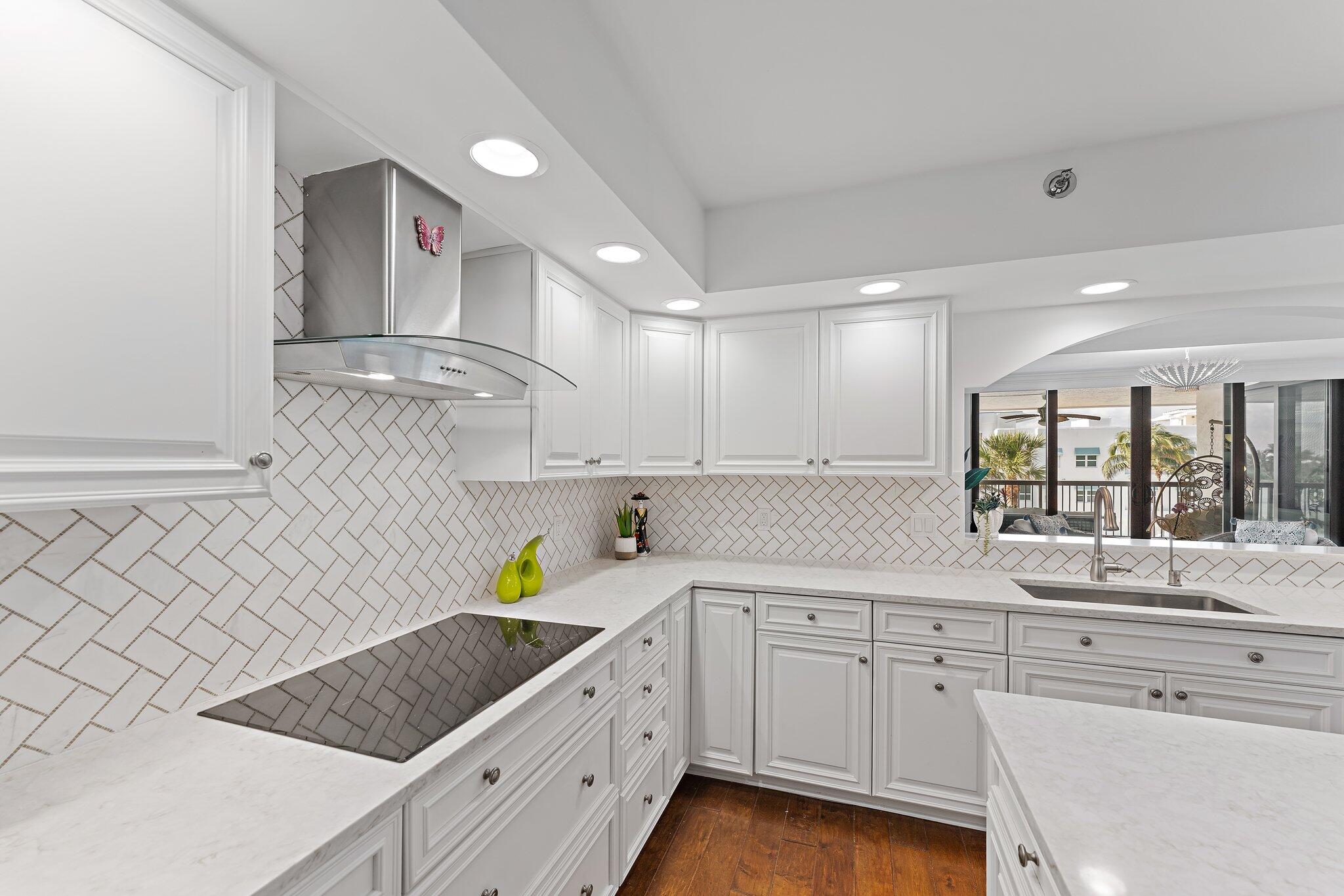 19670 South Beach Road, Unit B303 Jupiter, FL 33469 - Photo 9 of 104 a kitchen with a sink window and cabinets