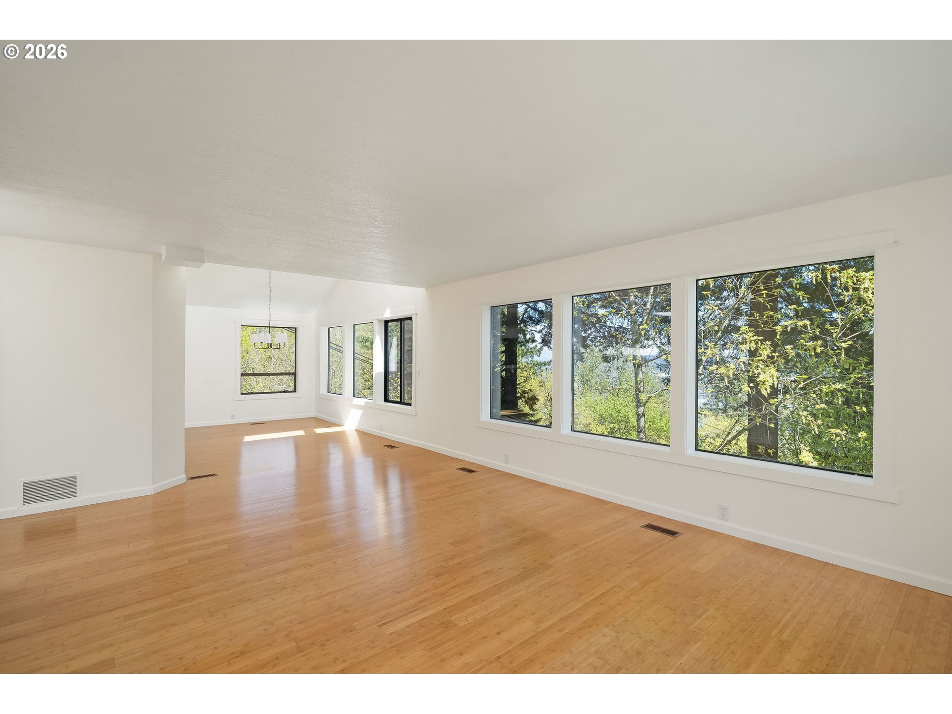 5844 Southwest Ralston Drive Portland, OR 97239 - Photo 16 of 43 a view of an empty room with wooden floor and a window