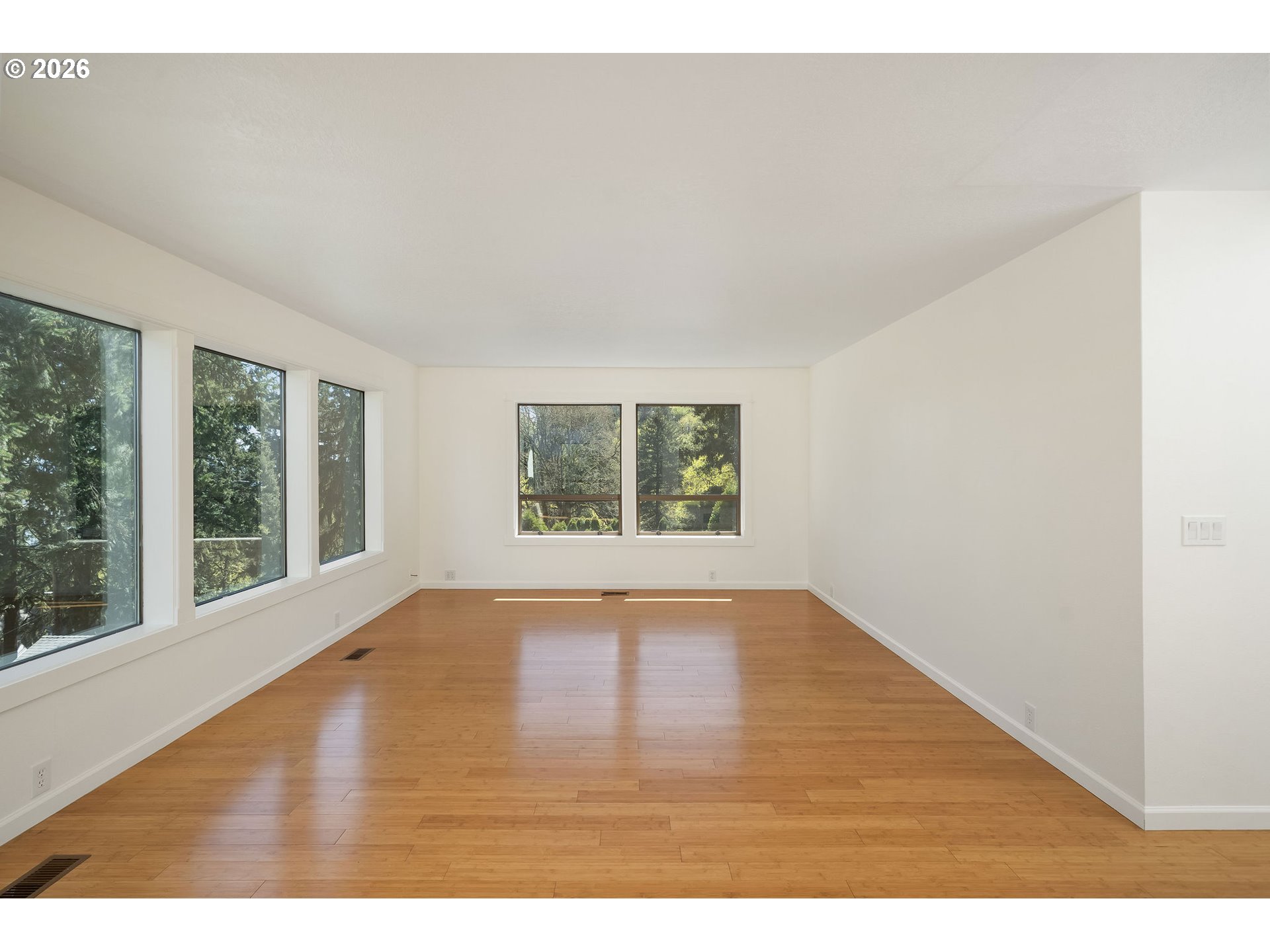5844 Southwest Ralston Drive Portland, OR 97239 - Photo 18 of 43 a view of an empty room with wooden floor and a window