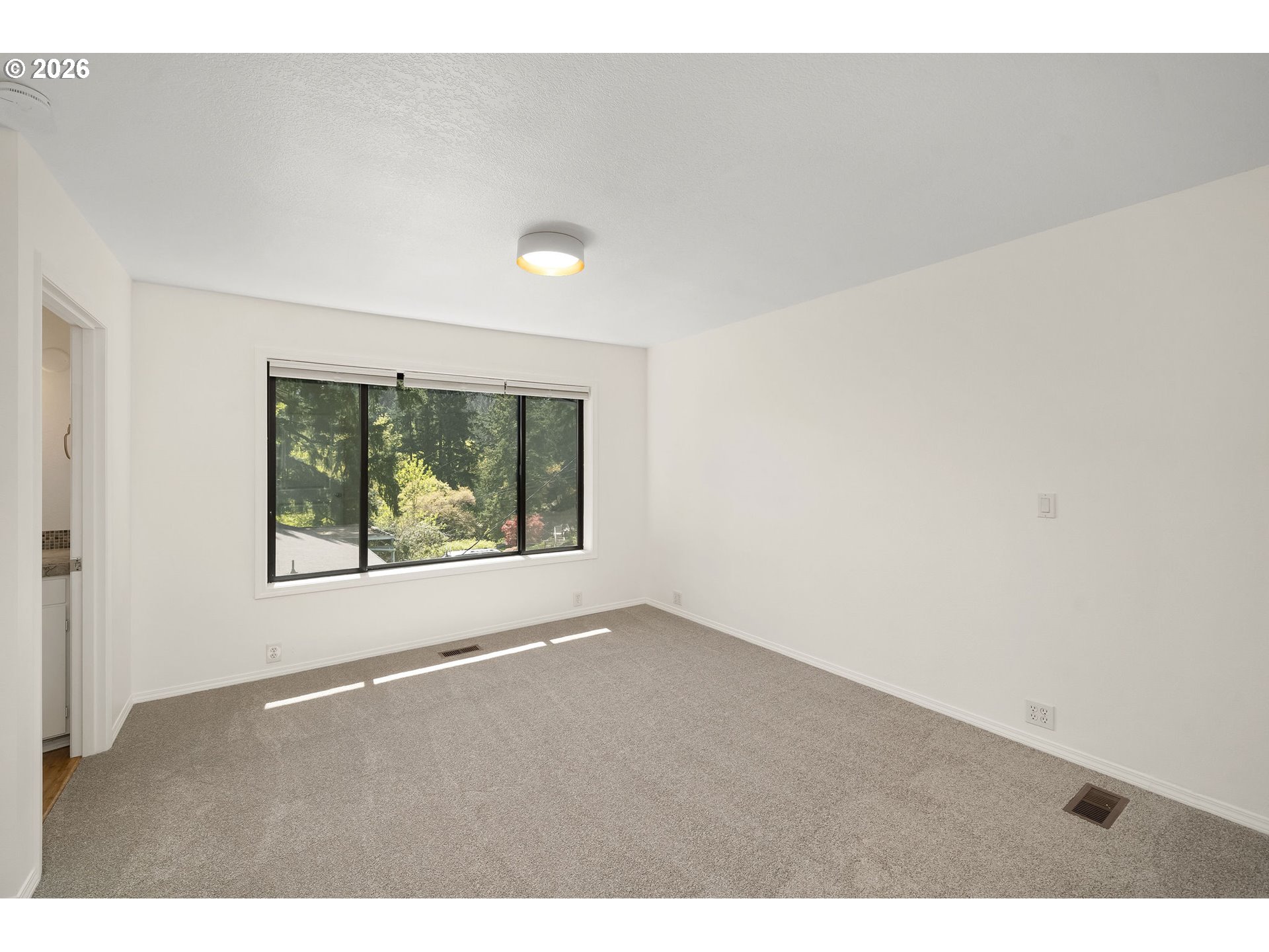 5844 Southwest Ralston Drive Portland, OR 97239 - Photo 20 of 43 a view of an empty room with a window