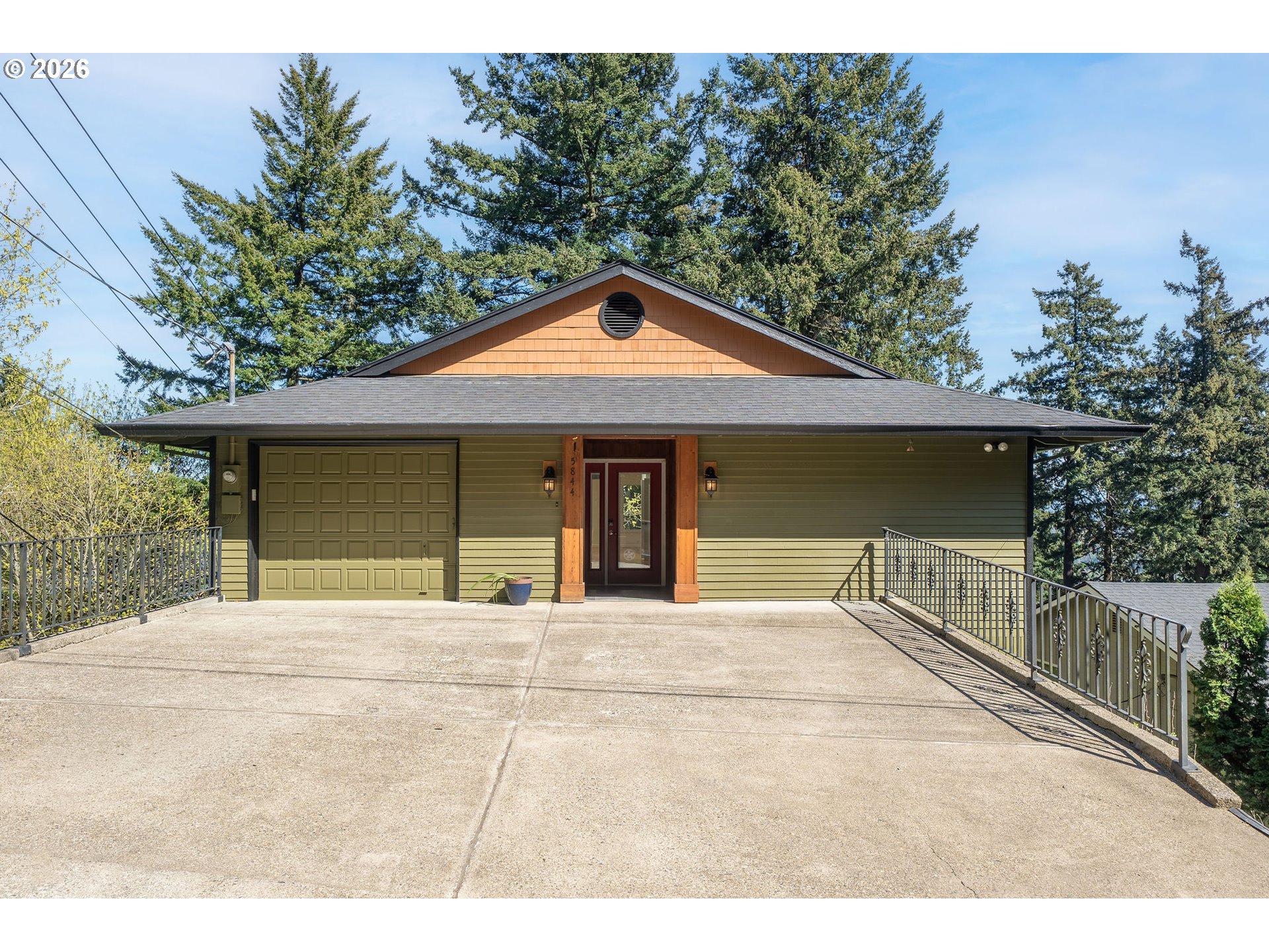 5844 Southwest Ralston Drive Portland, OR 97239 - Photo 2 of 43 a front view of a house with a garage