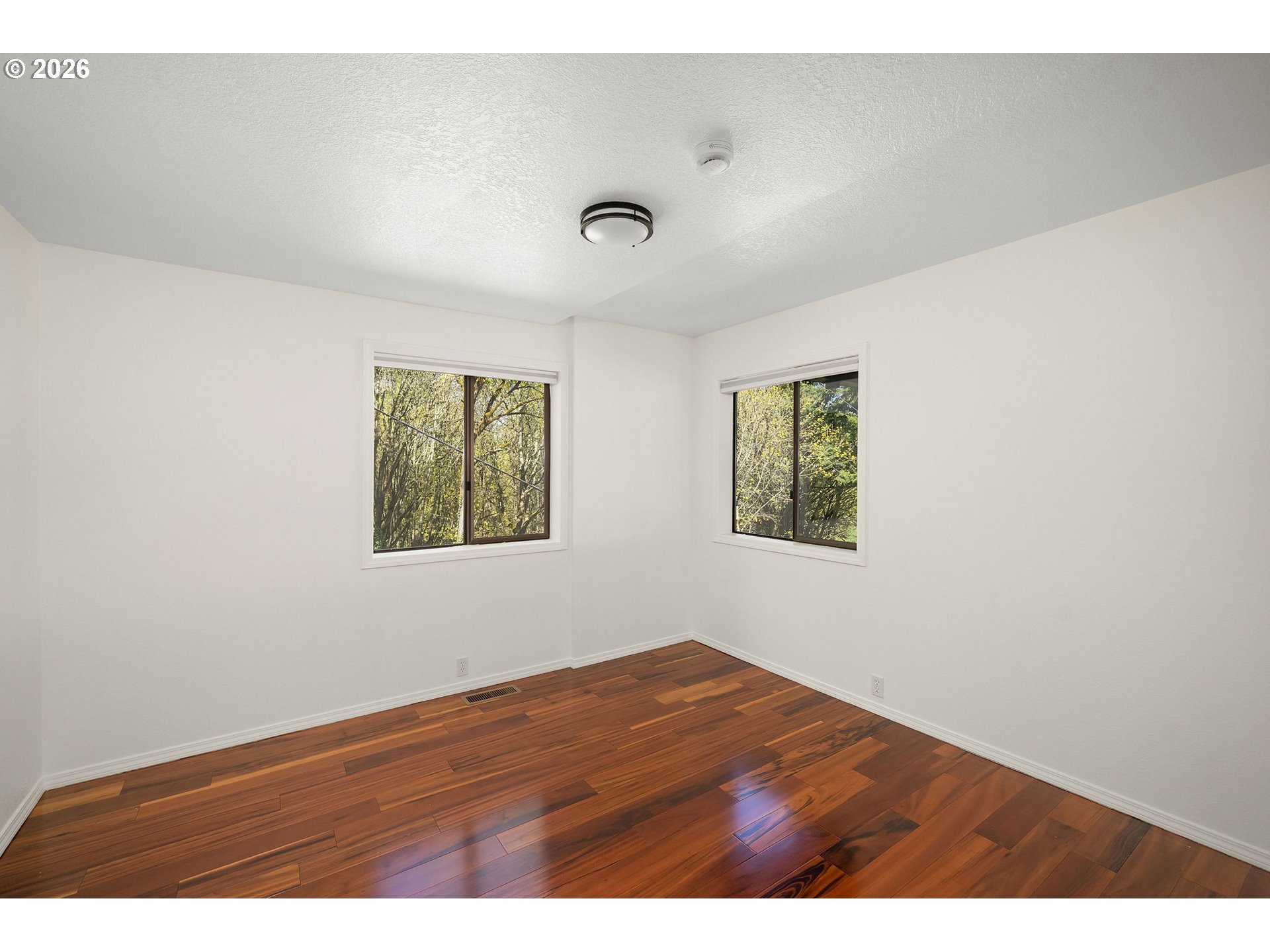 5844 Southwest Ralston Drive Portland, OR 97239 - Photo 32 of 43 a view of an empty room with wooden floor and a window