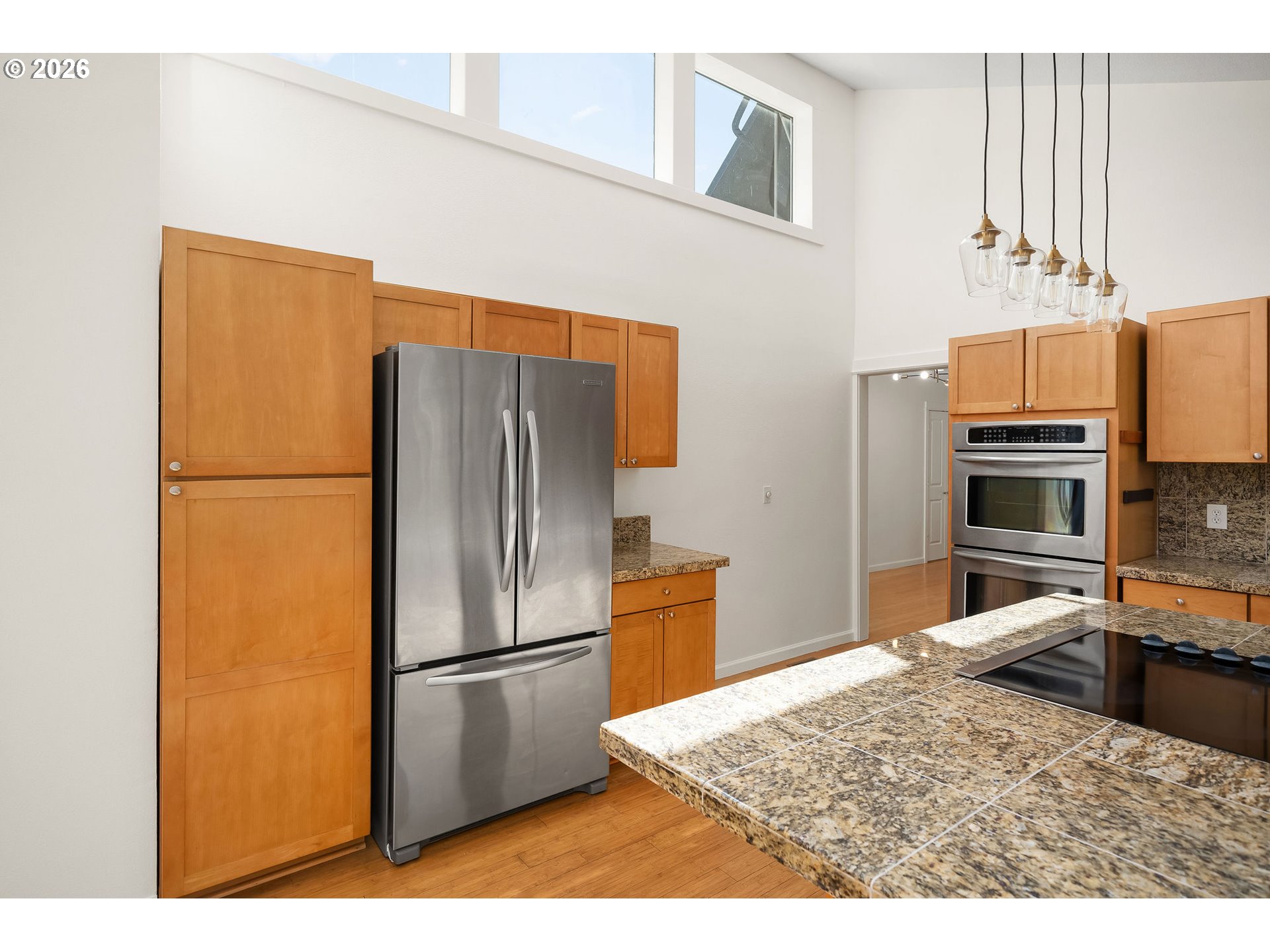 5844 Southwest Ralston Drive Portland, OR 97239 - Photo 9 of 43 a kitchen with stainless steel appliances granite countertop a refrigerator a stove and a sink