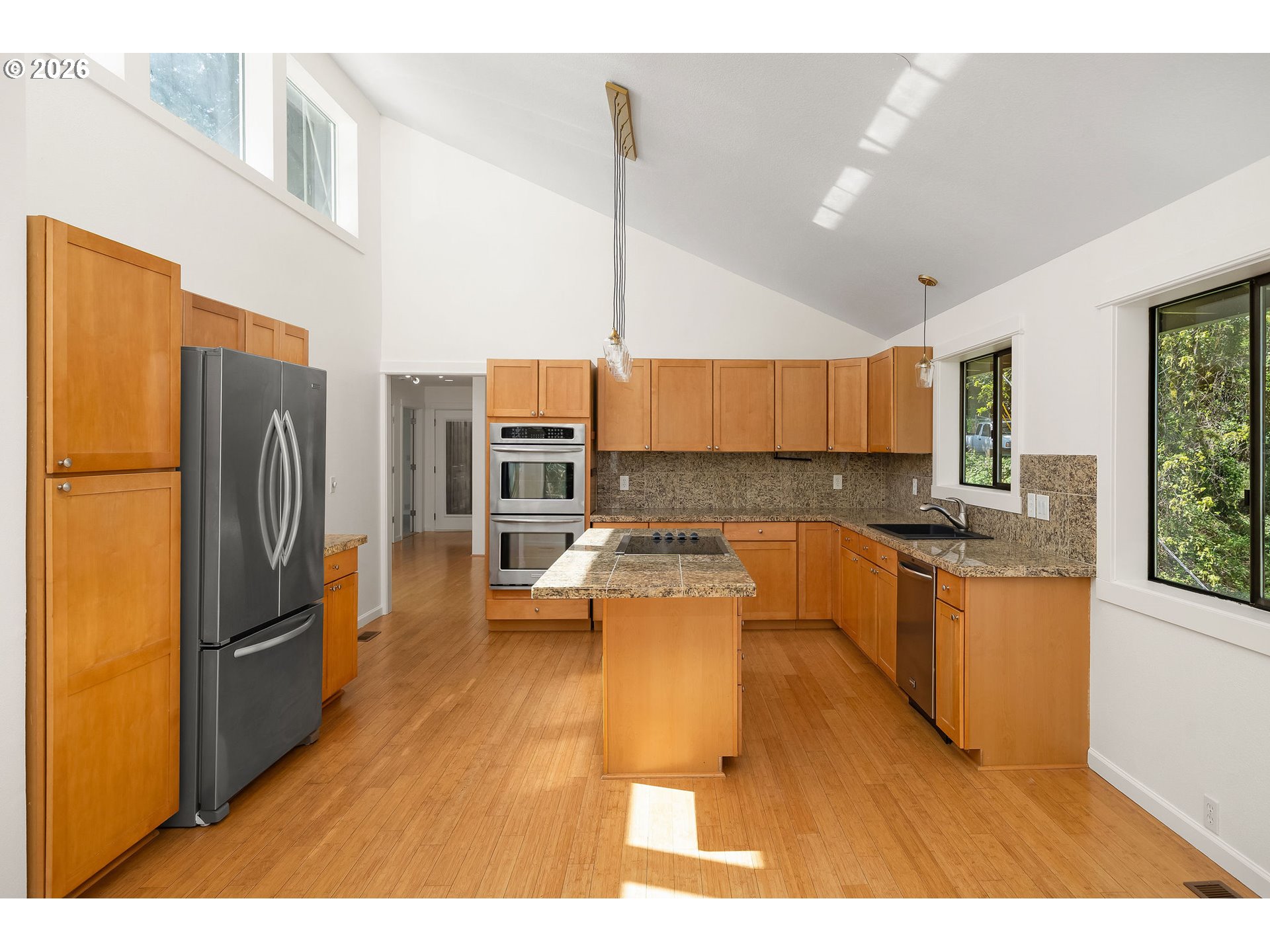 5844 Southwest Ralston Drive Portland, OR 97239 - Photo 10 of 43 a kitchen with stainless steel appliances granite countertop a refrigerator a sink a stove and island
