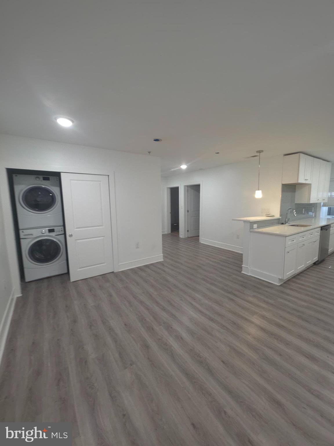 3925 Haverford Avenue, Unit LL2 Philadelphia, PA 19104 - Photo 27 of 38 a view of kitchen and empty room with wooden floor