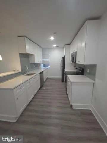 a kitchen with a sink stove and cabinets