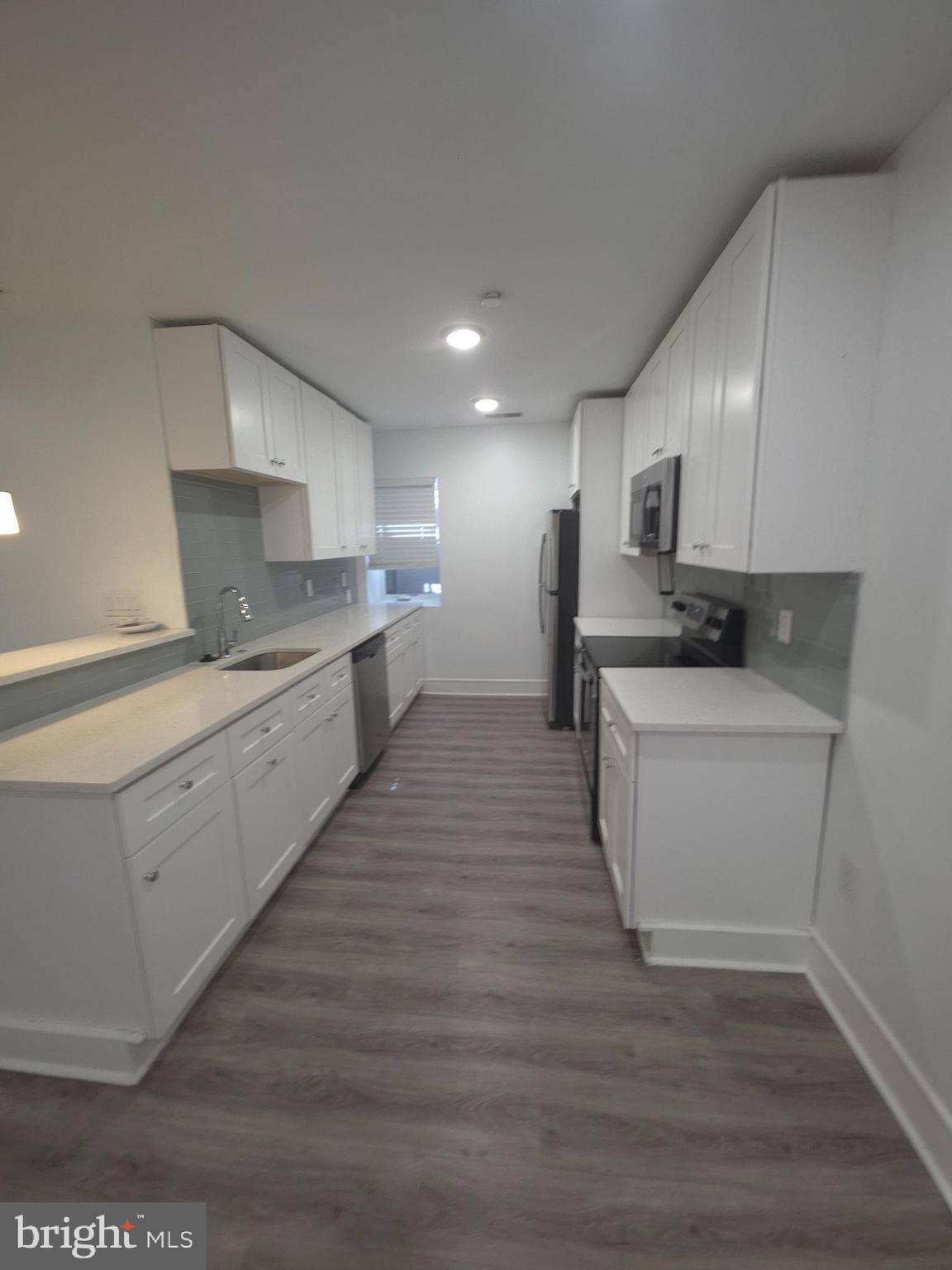 3925 Haverford Avenue, Unit LL2 Philadelphia, PA 19104 - Photo 28 of 38 a kitchen with a sink stove and cabinets