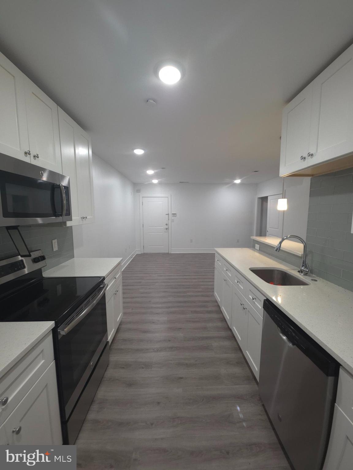 3925 Haverford Avenue, Unit LL2 Philadelphia, PA 19104 - Photo 29 of 38 a large kitchen with granite countertop a sink and a stove top oven