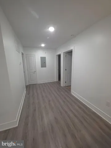 a view of a room with wooden floor and window