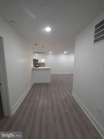 a view of a kitchen with a sink and dishwasher wooden floor