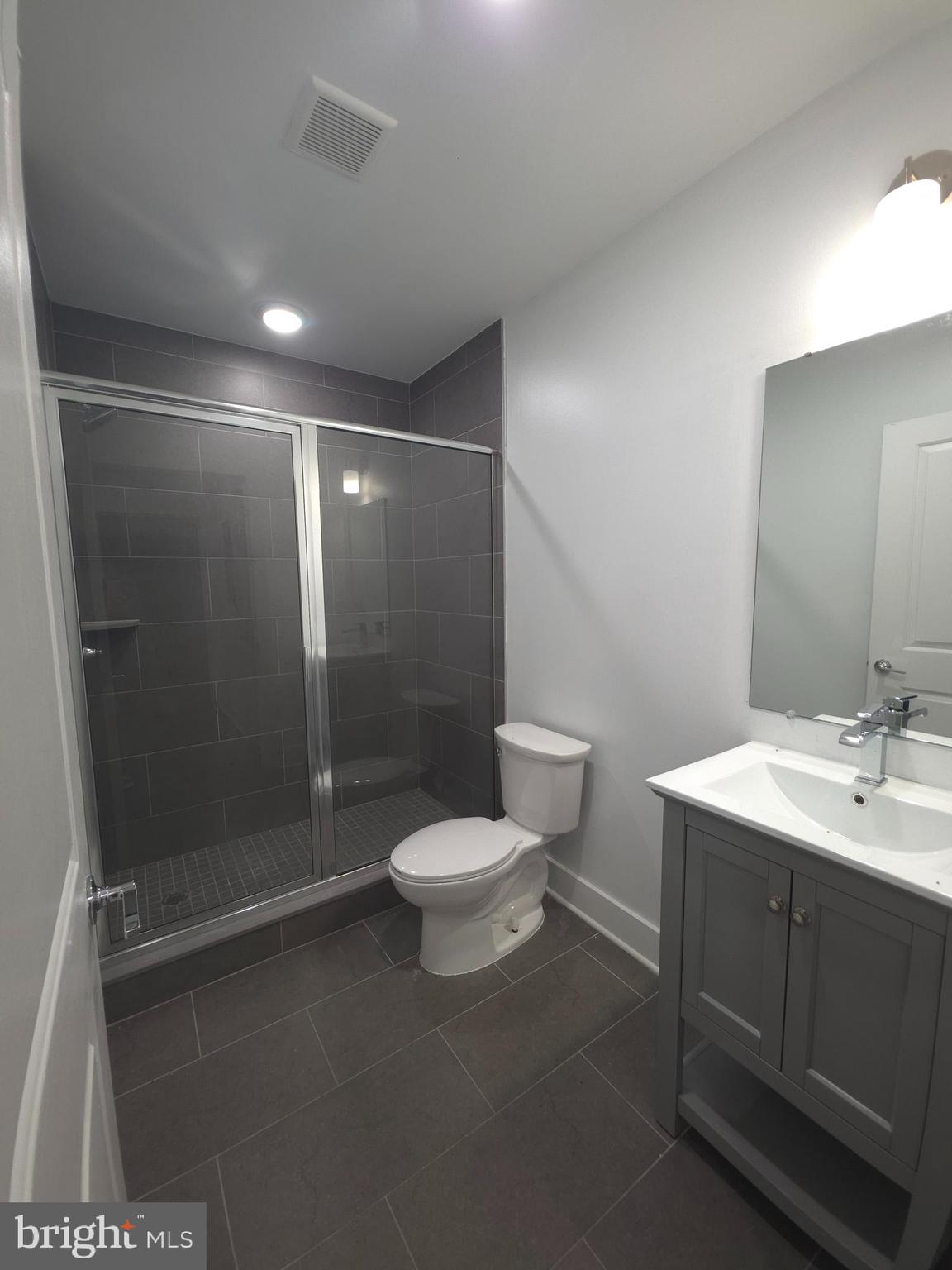 3925 Haverford Avenue, Unit LL2 Philadelphia, PA 19104 - Photo 34 of 38 a bathroom with a shower sink vanity and toilet