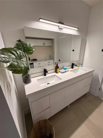 a living room with toilet a sink and a large window