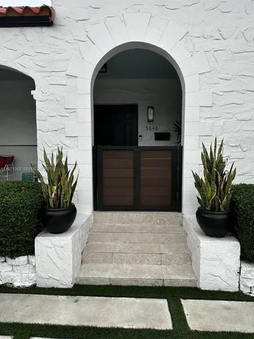 a white building with potted plants