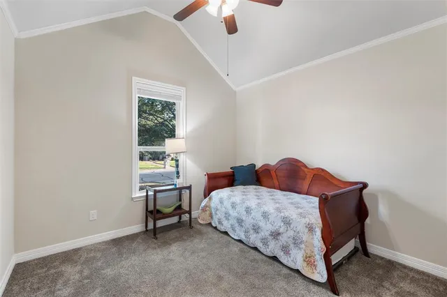 a bedroom with a bed and a chandelier fan