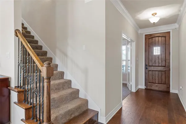 a view of entryway and hall with wooden floor