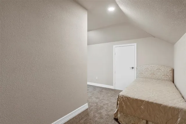 a bedroom with a bed and a lamp