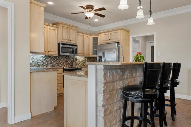 a kitchen with a table chairs refrigerator and microwave