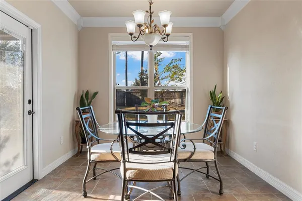 a view of a dining room with furniture and a chandelier