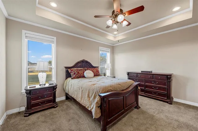a bedroom with a bed and a ceiling fan