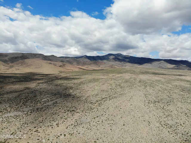 a view of an ocean beach and mountain