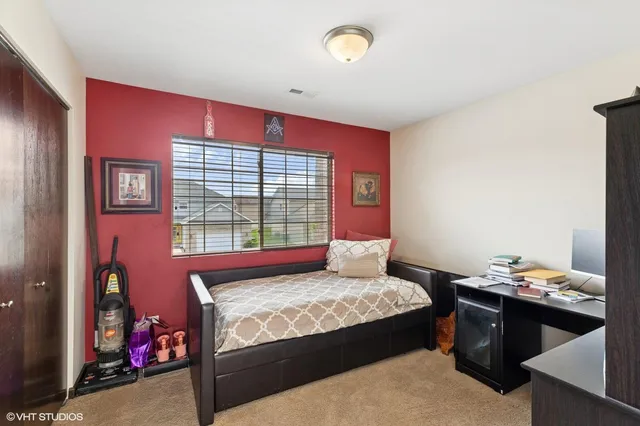 a bedroom with a bed and a window