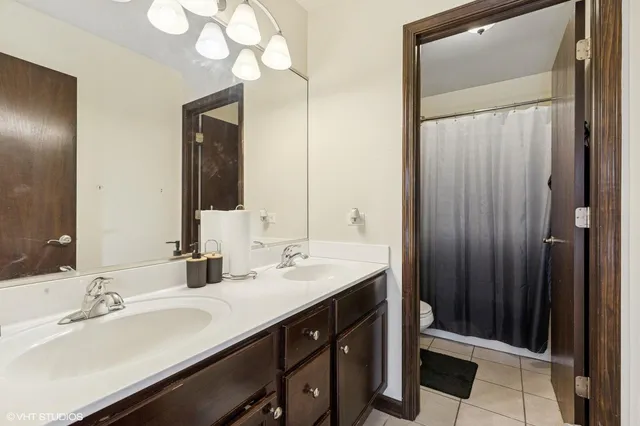 a bathroom with a double vanity sink and a mirror