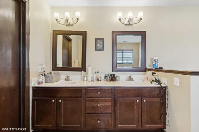 a bathroom with a double vanity sink and a mirror