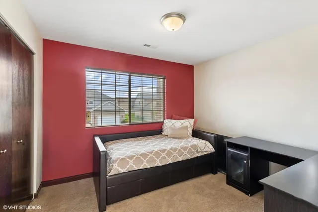 a bedroom with a bed and a window