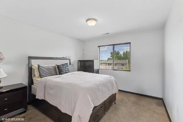 a bedroom with a bed and window