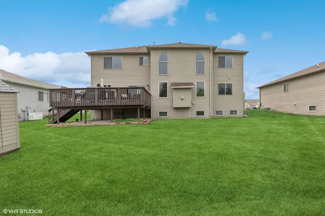 a view of a house with a big yard and large trees