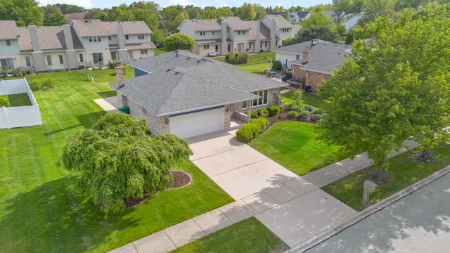 an aerial view of multiple houses with a yard
