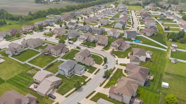an aerial view of residential houses with outdoor space