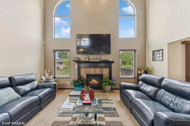 a living room with furniture and a fireplace