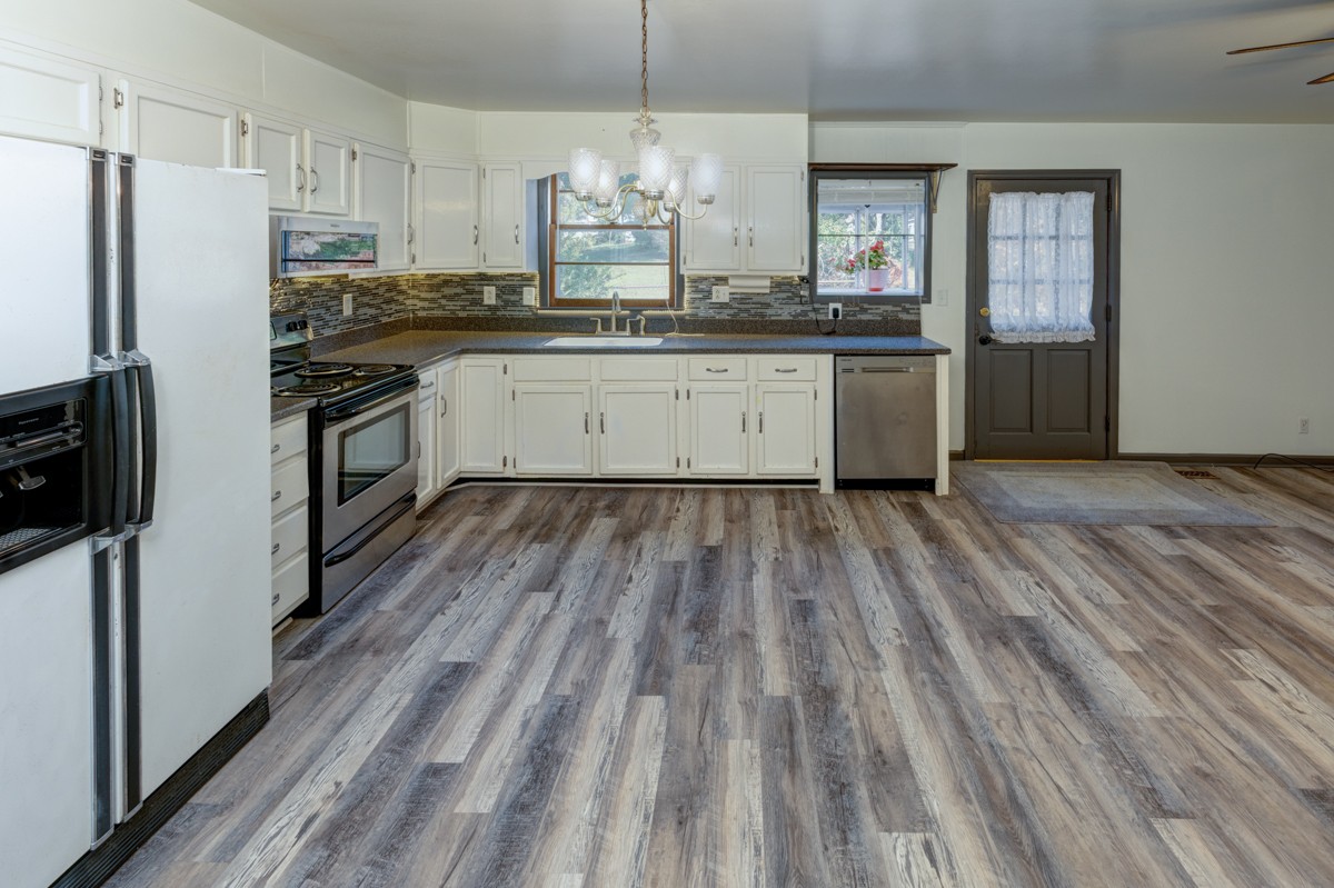 3228 Anderson Road Antioch, TN 37013 - Photo 12 of 61 a kitchen with wooden floors and white cabinets