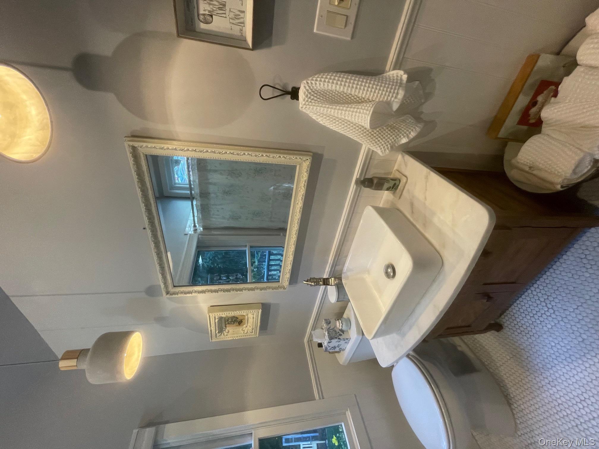 70 Shell Road Rocky Point, NY 11778 - Photo 13 of 31 Bathroom featuring wainscoting, vanity, a shower, and a decorative wall