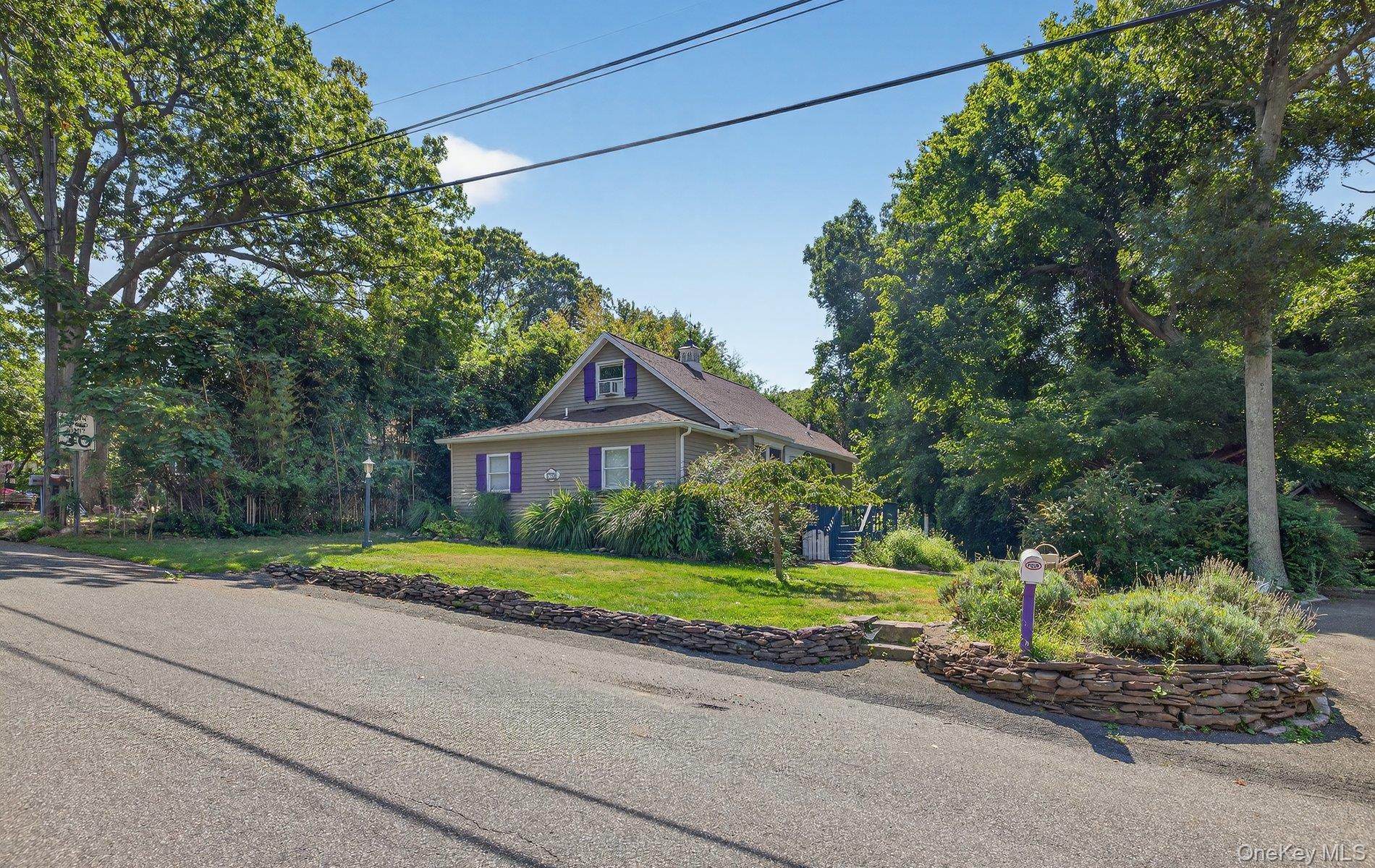 70 Shell Road Rocky Point, NY 11778 - Photo 26 of 31 View of front of property with a front lawn, a chimney, and view of wooded area