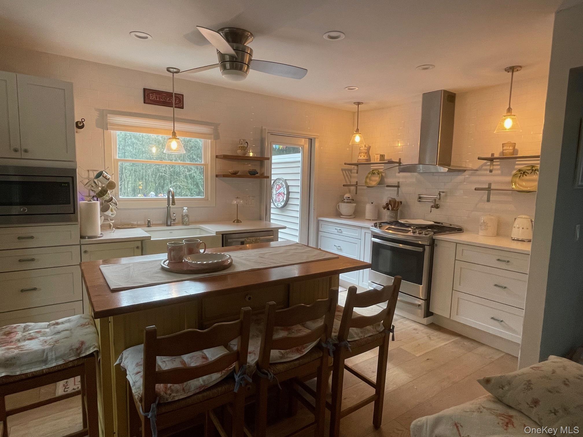 70 Shell Road Rocky Point, NY 11778 - Photo 4 of 31 Kitchen featuring open shelves, decorative backsplash, appliances with stainless steel finishes, hanging light fixtures, and recessed lighting
