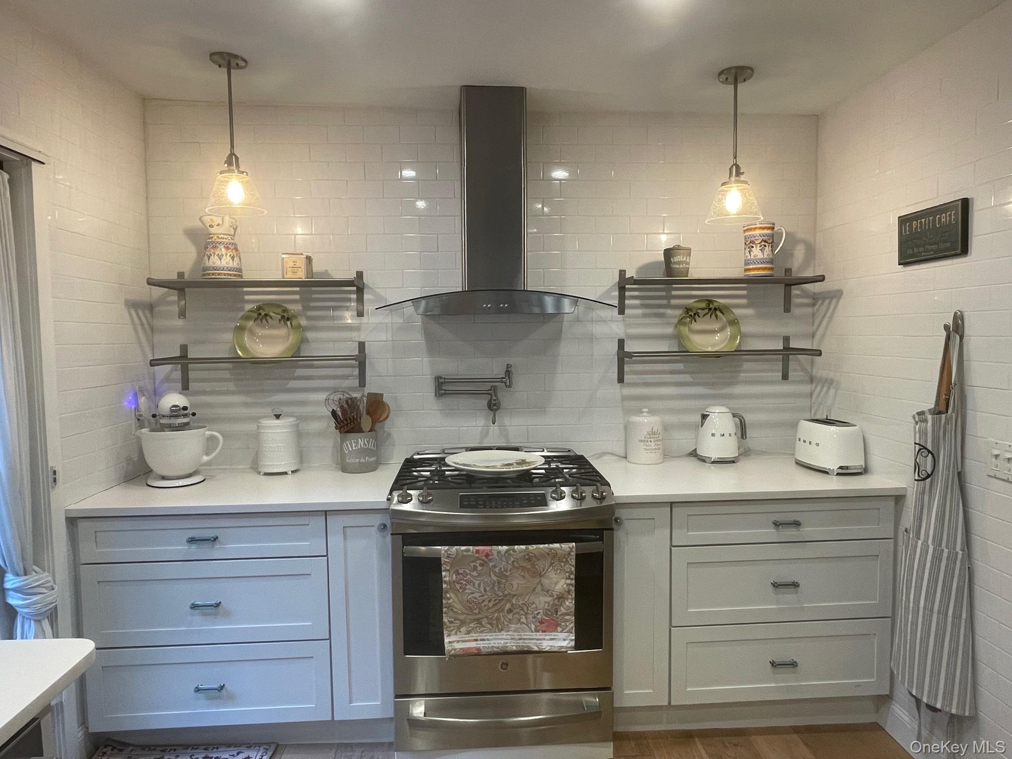 70 Shell Road Rocky Point, NY 11778 - Photo 5 of 31 Bar featuring open shelves, gas range, wall chimney range hood, and tasteful backsplash
