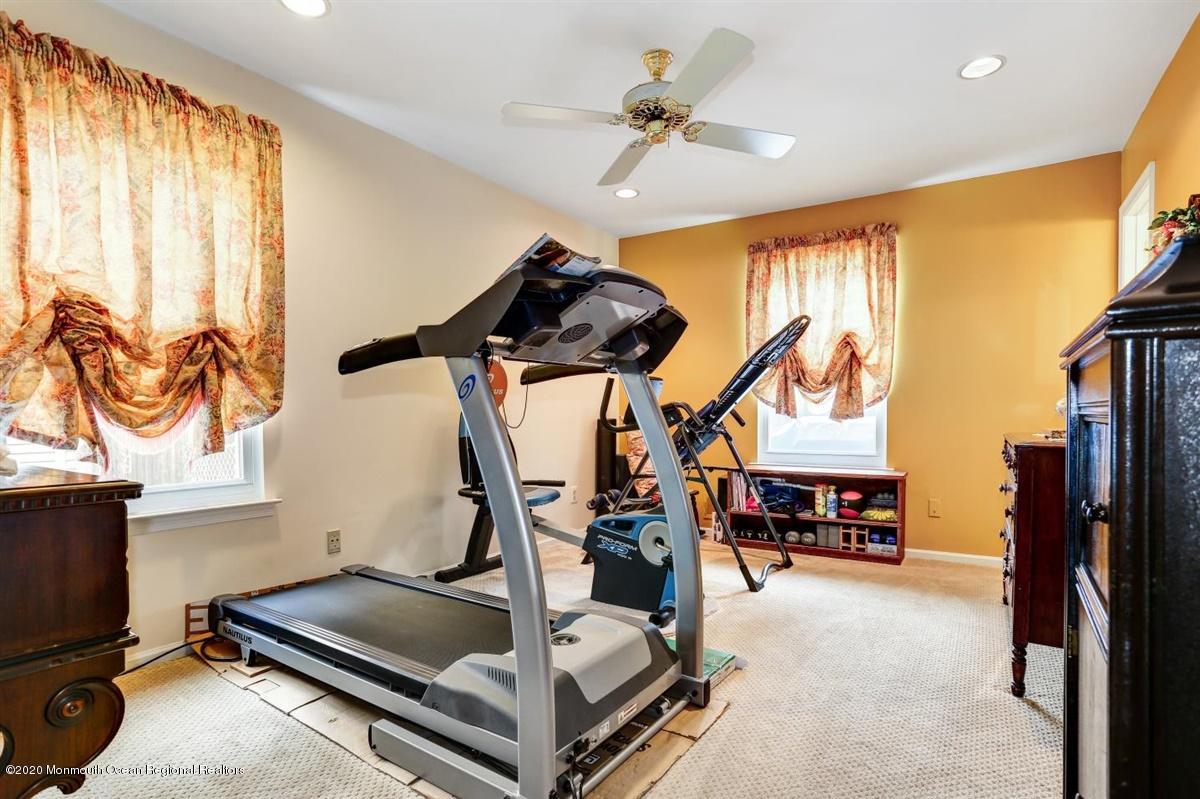 40 Hedgewood Road Howell, NJ 07731 - Photo 28 of 39 a bedroom with furniture and a flat screen tv