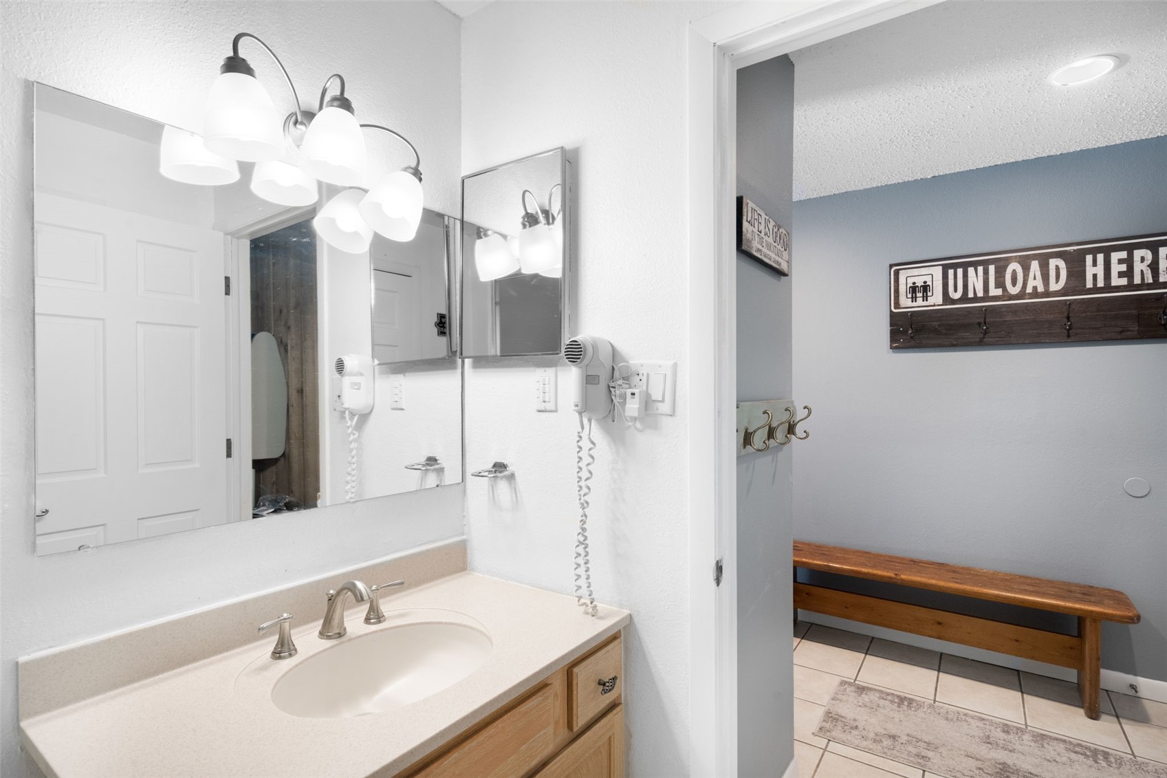 760 Copper Road, Unit F204 Copper Mountain, CO 80443 - Photo 23 of 32 Bathroom with vanity, light tile patterned floors, a chandelier, and a textured ceiling