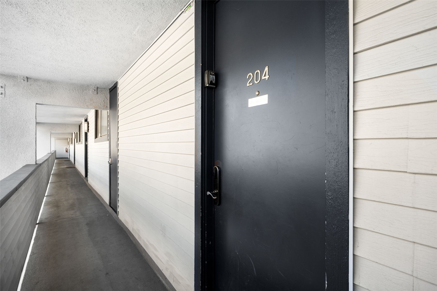 760 Copper Road, Unit F204 Copper Mountain, CO 80443 - Photo 24 of 32 Hallway with a textured ceiling and a textured wall