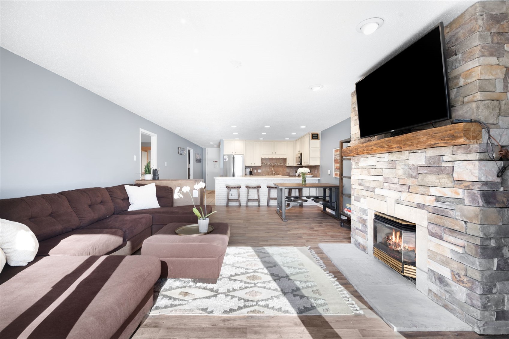 760 Copper Road, Unit F204 Copper Mountain, CO 80443 - Photo 5 of 32 Living area with light wood-type flooring, a fireplace, and recessed lighting