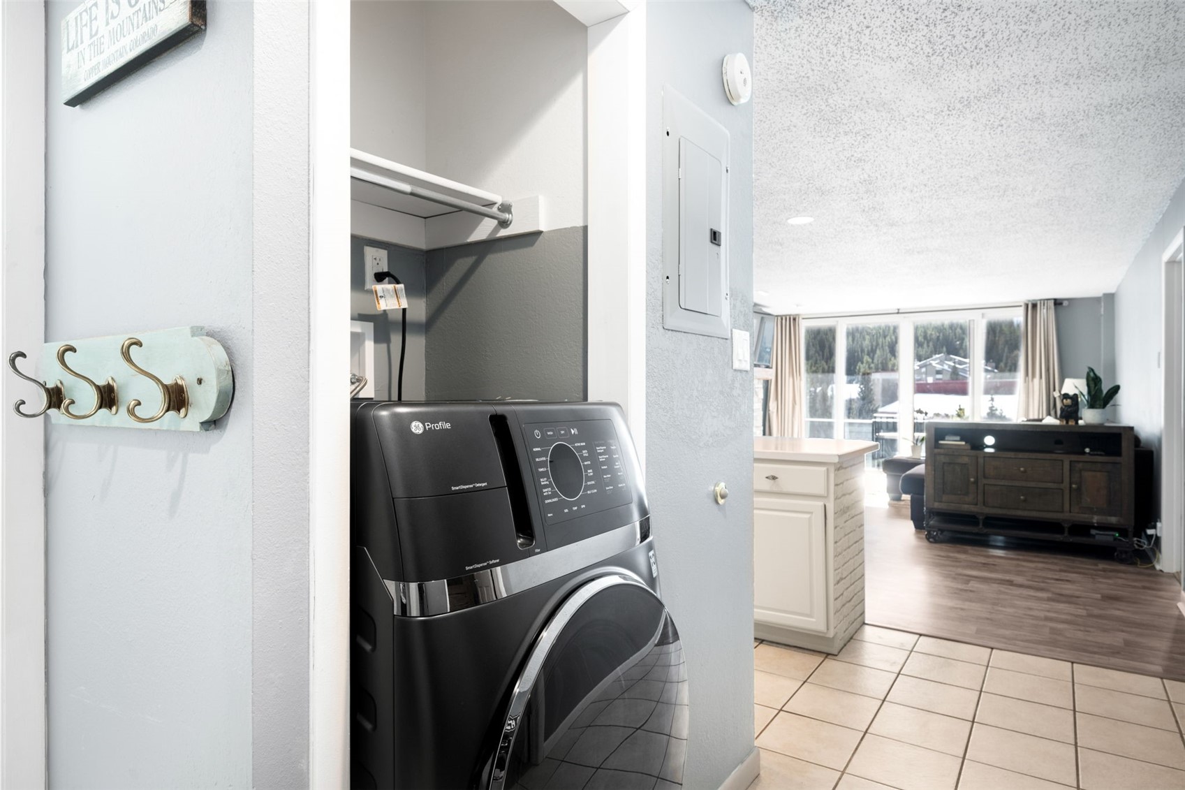 760 Copper Road, Unit F204 Copper Mountain, CO 80443 - Photo 9 of 32 Washroom featuring washer / clothes dryer, a textured ceiling, light tile patterned floors, and electric panel