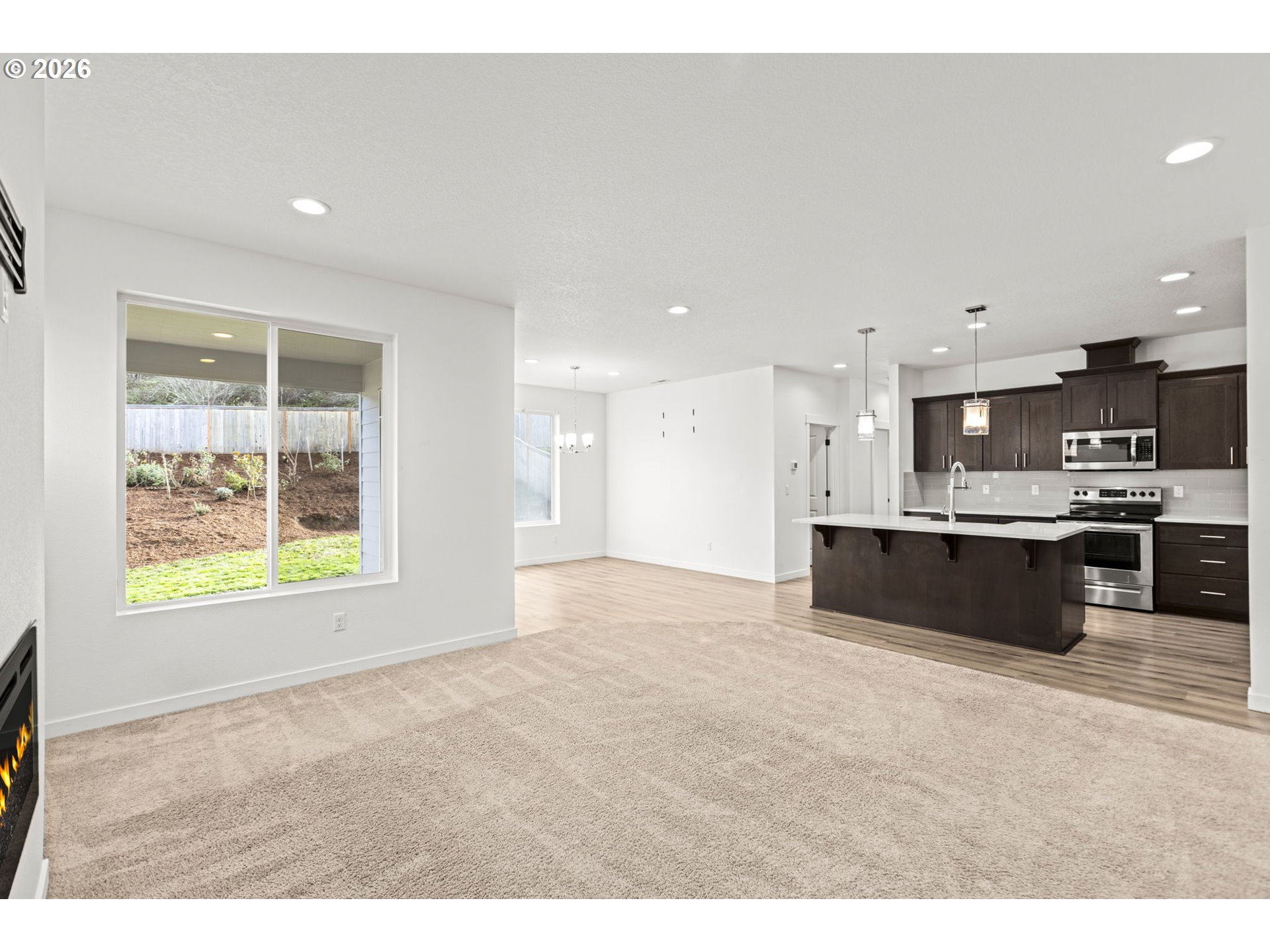 3513 Northeast Claire Road Estacada, OR 97023 - Photo 11 of 42 a view of kitchen with kitchen island stainless steel appliances a sink dishwasher and a fireplace