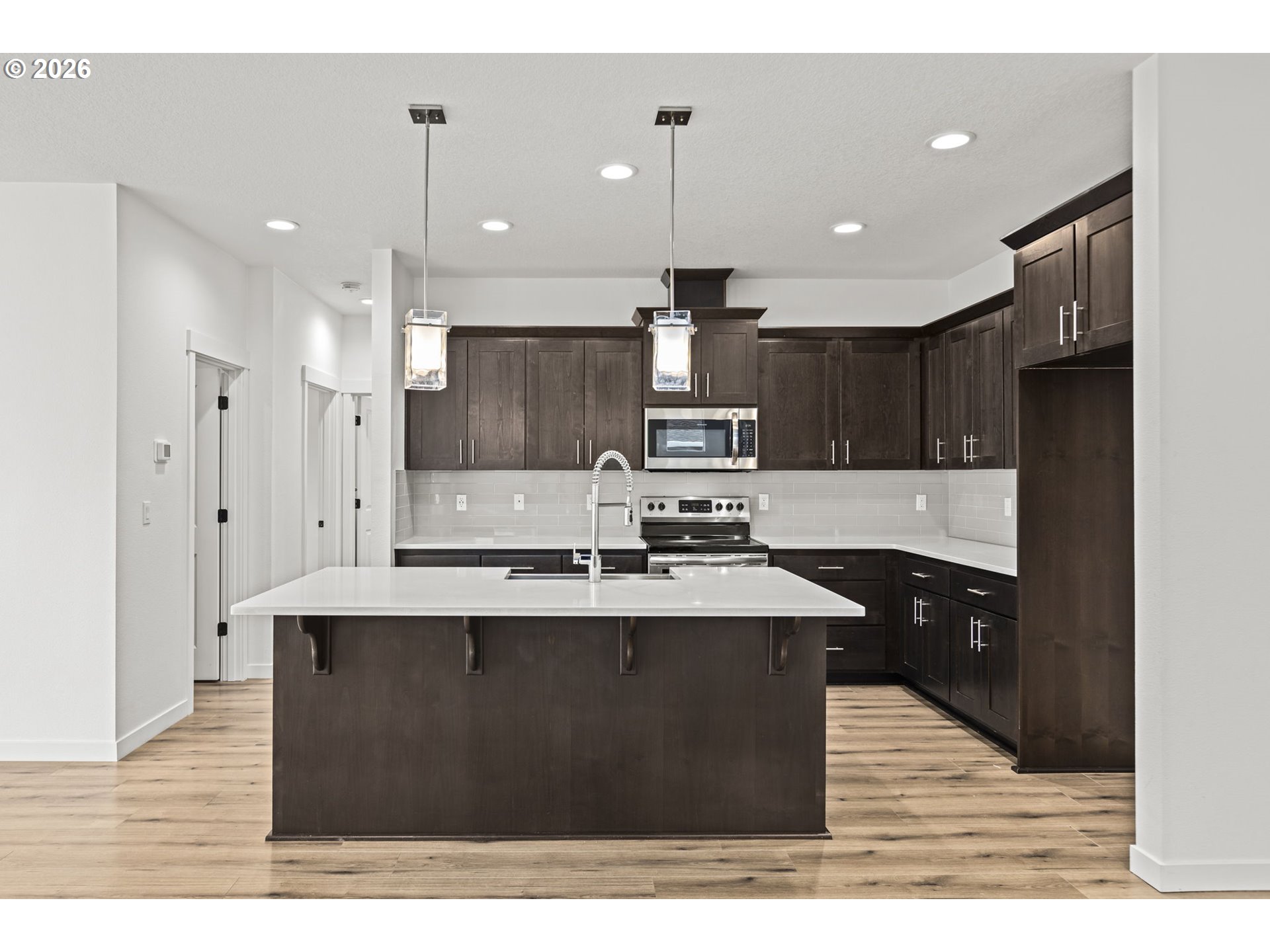 3513 Northeast Claire Road Estacada, OR 97023 - Photo 12 of 42 a kitchen with stainless steel appliances kitchen island granite countertop a sink a stove a refrigerator and a cabinets